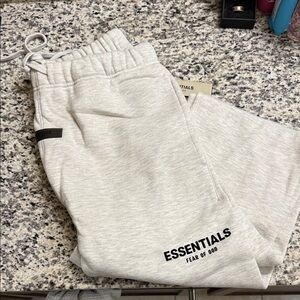 Fear of God ESSENTIALS Heather Light Gray Sweatpants with Black Logo
